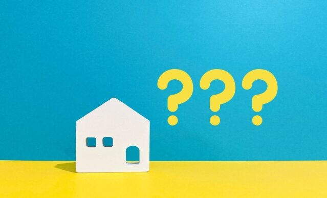 Small white house icon beside three yellow question marks on a blue and yellow backdrop, signaling questions about housing or homeownership.