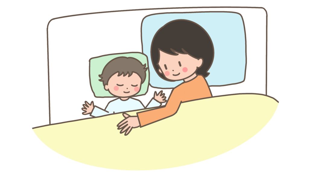 Mother and young child in bed, smiling and holding hands under a blanket.
